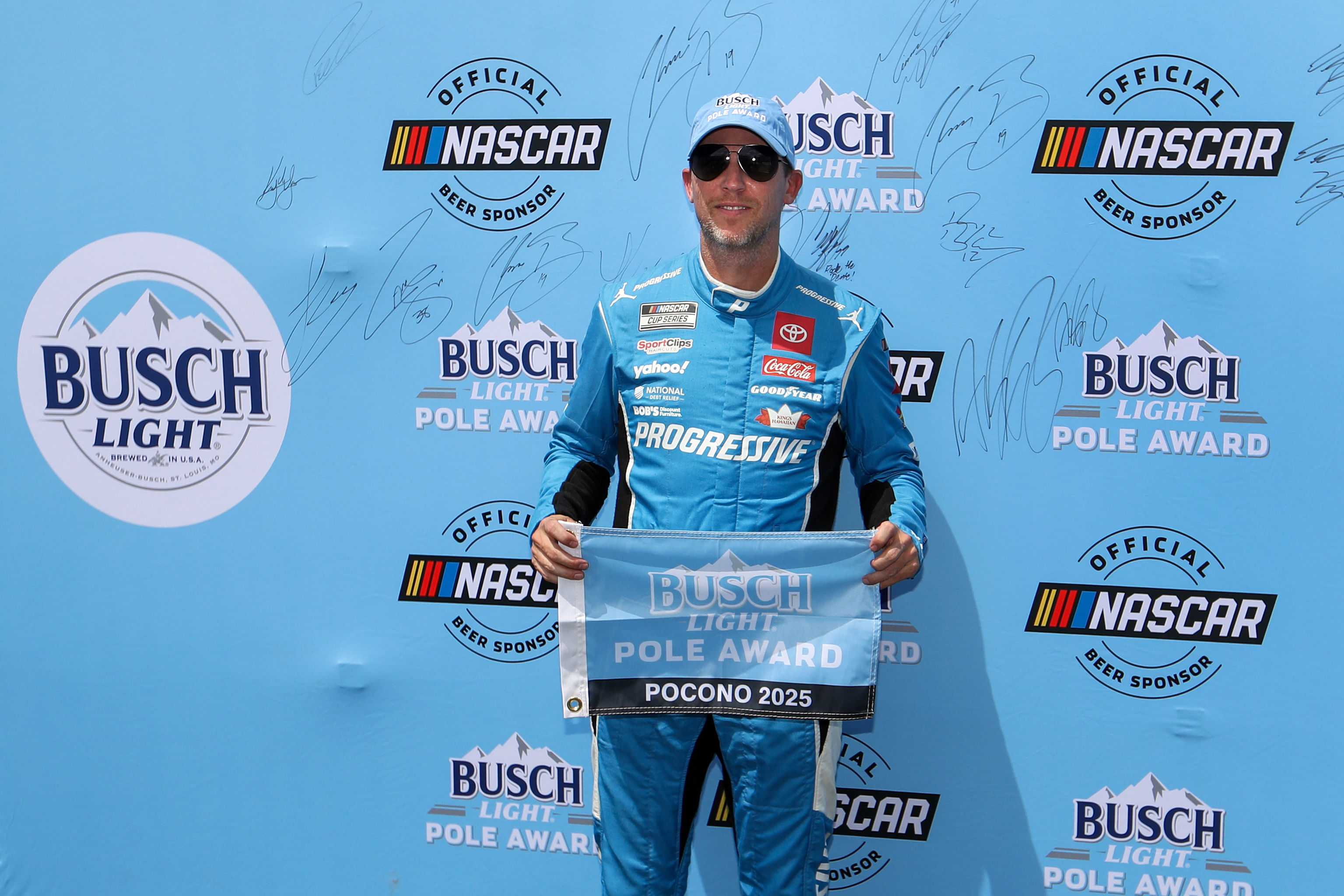 NASCAR Cup Series driver Denny Hamlin stands with the Busch Light Pole Award after winning the pole for The Great American Getaway 400 at Pocono Raceway - Source: Imagn